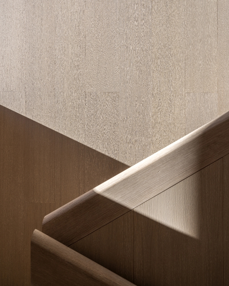 Close-up of light and dark wood textures with geometric play of light and shadow.