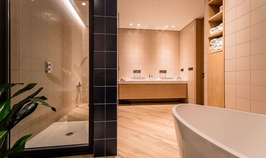 Elegante cuarto de baño que destaca por su amplia bañera exenta y zona de ducha separada.